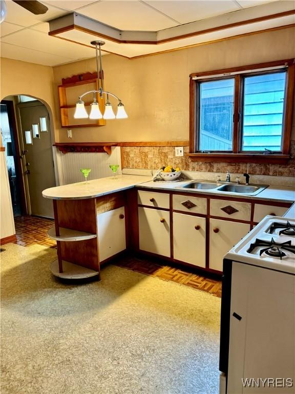 150 Weiss St, Buffalo, NY 14206 - kitchen featuring white range oven, arched walkways, open shelves, pendant lighting, and a peninsula