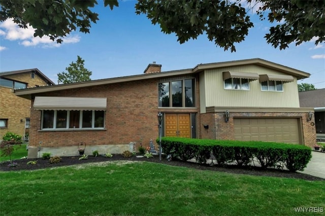 2503 Parkview Dr, Niagara Falls, NY 14305 - view of front of property featuring brick siding, a front yard, a chimney, and an attached garage