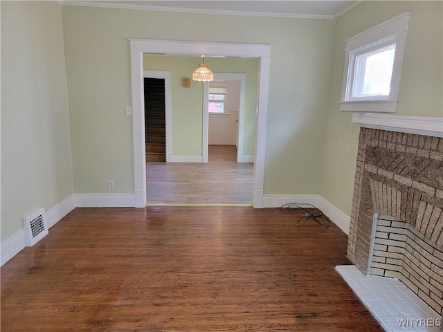 2255 Ontario Ave, Niagara Falls, NY 14305 - unfurnished dining area featuring ornamental molding, a brick fireplace, and wood finished floors
