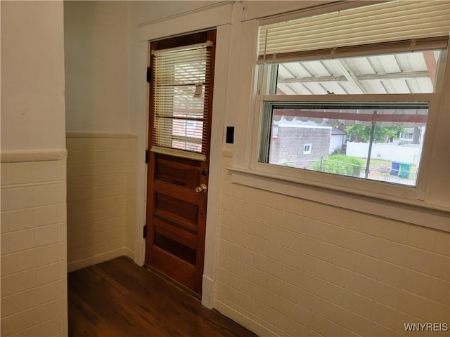 2255 Ontario Ave, Niagara Falls, NY 14305 - doorway featuring dark wood-type flooring, healthy amount of natural light, tile walls, and a wainscoted wall