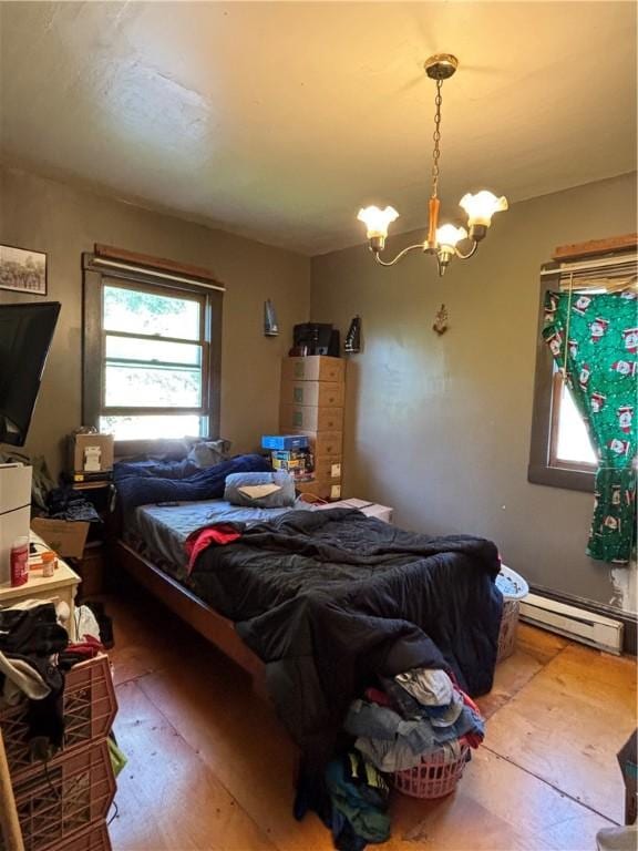 516 Hacker St, Kane Boro, PA 16735 - bedroom with a baseboard heating unit, multiple windows, a chandelier, and wood finished floors