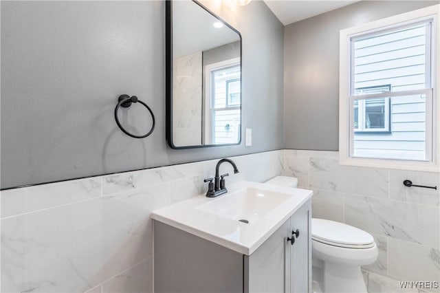 192 Culver Rd, Buffalo, NY 14220 - half bathroom with tile walls, vanity, and a wainscoted wall