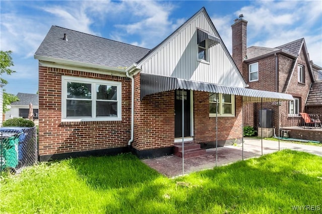 192 Culver Rd, Buffalo, NY 14220 - back of property with brick siding, board and batten siding, entry steps, and a yard