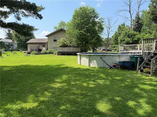 205 Darla Dr, Clarkson, NY 14420 - view of grassy yard featuring a wooden deck and an outdoor pool
