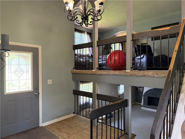 205 Darla Dr, Clarkson, NY 14420 - entrance foyer featuring a chandelier, plenty of natural light, and a textured ceiling