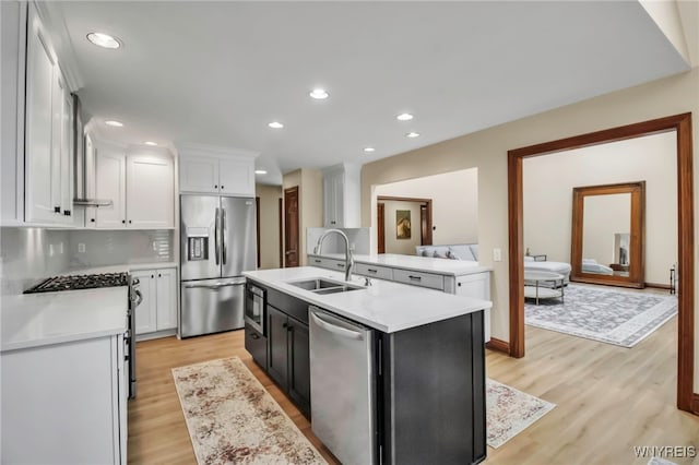 6290 Emily Ct, Clarence, NY 14032 - kitchen featuring appliances with stainless steel finishes, light countertops, light wood finished floors, white cabinets, and recessed lighting