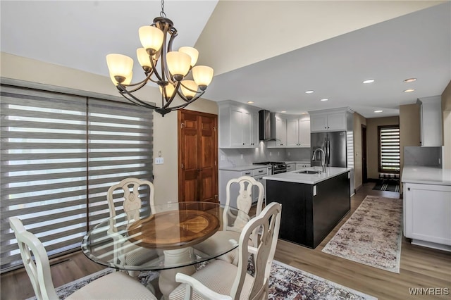 6290 Emily Ct, Clarence, NY 14032 - dining space with a chandelier, wood finished floors, and recessed lighting