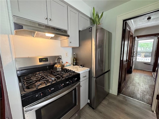 714 Arnett Blvd, Rochester, NY 14619 - kitchen featuring appliances with stainless steel finishes, under cabinet range hood, and wood finished floors