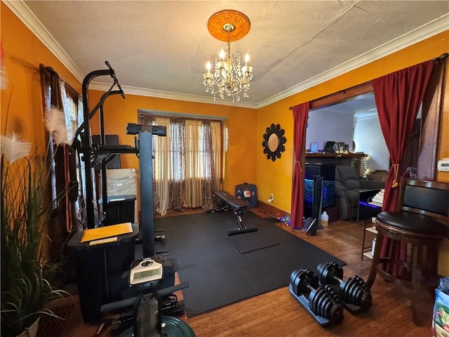714 Arnett Blvd, Rochester, NY 14619 - workout room with a chandelier, crown molding, a textured ceiling, and wood finished floors