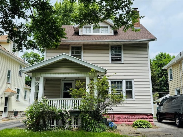 714 Arnett Blvd, Rochester, NY 14619 - american foursquare style home featuring covered porch, a shingled roof, and a chimney