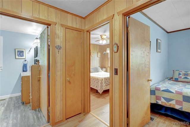 6557 Boberg Rd, Ashford, NY 14171 - corridor with light wood finished floors, ornamental molding, and wooden walls