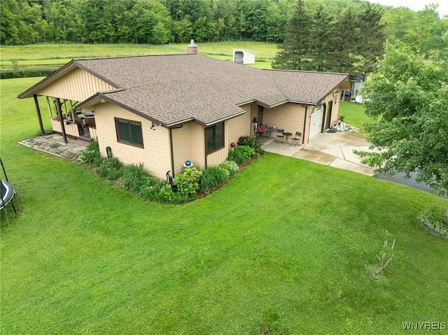6557 Boberg Rd, Ashford, NY 14171 - view of front of house with roof with shingles, a front lawn, concrete driveway, and a garage