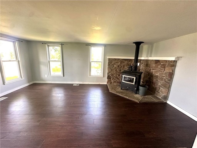 14918 Lakeshore Rd, Carlton, NY 14477 - unfurnished living room with a wood stove and wood finished floors
