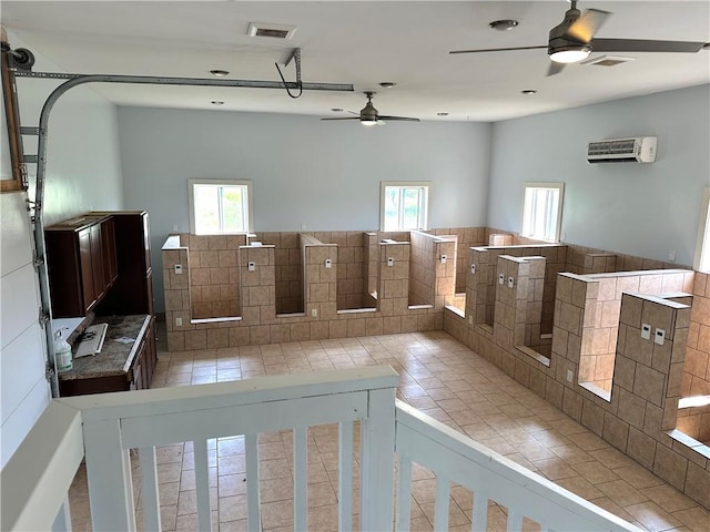 14918 Lakeshore Rd, Carlton, NY 14477 - unfurnished living room with a ceiling fan, tile patterned floors, an AC wall unit, and healthy amount of natural light
