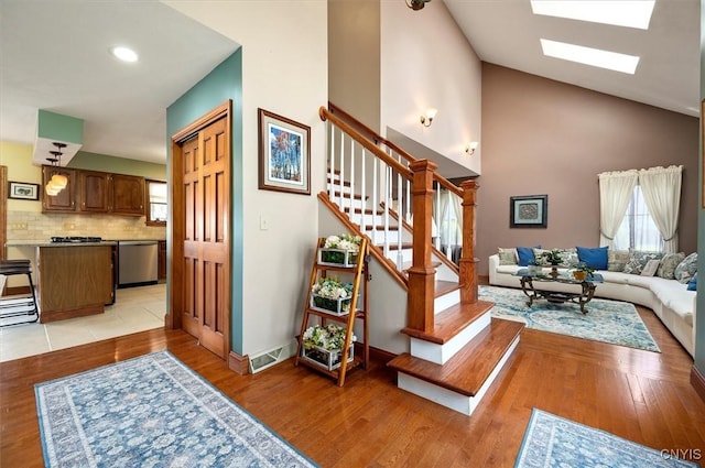 109 Hunt Valley Rd, Oneida-Inside, NY 13421 - staircase with a skylight, wood finished floors, high vaulted ceiling, and recessed lighting