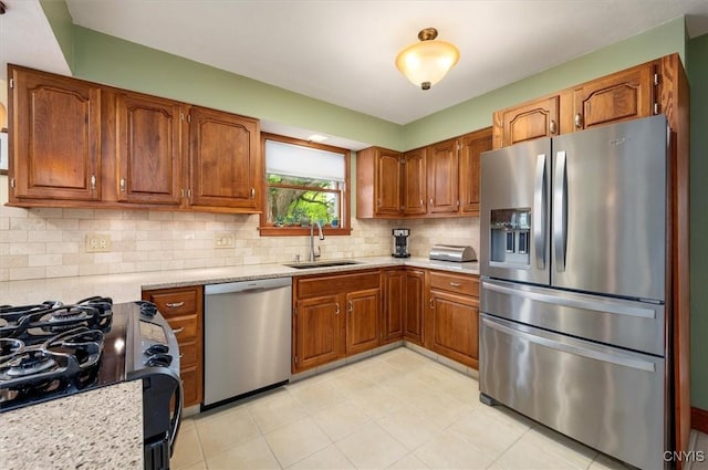 109 Hunt Valley Rd, Oneida-Inside, NY 13421 - kitchen with stainless steel appliances, brown cabinetry, tasteful backsplash, and light tile patterned flooring