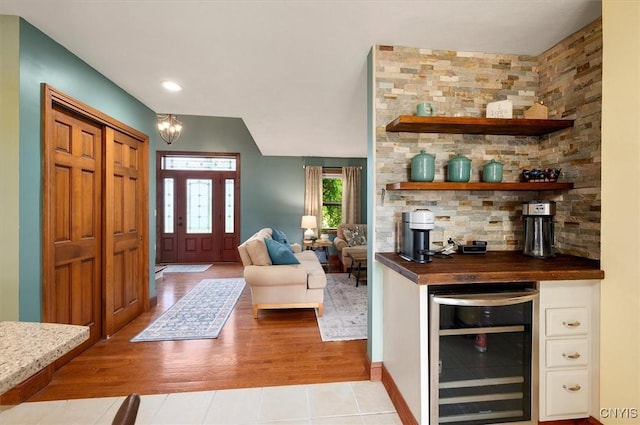 109 Hunt Valley Rd, Oneida-Inside, NY 13421 - entrance foyer featuring wine cooler, light wood-type flooring, a bar, a chandelier, and recessed lighting