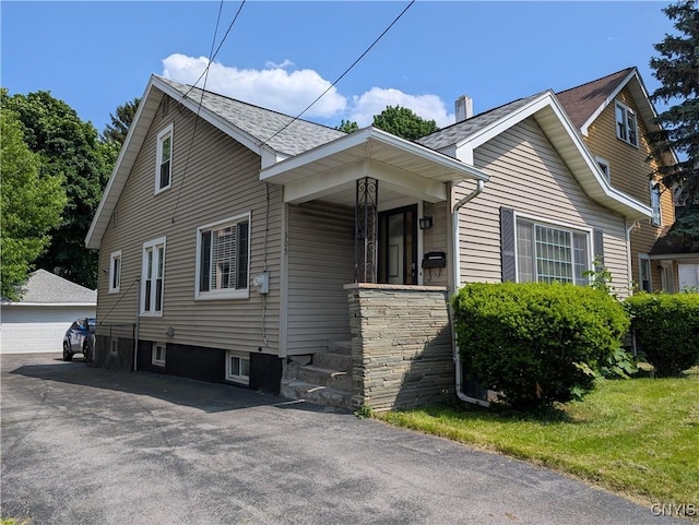 305 S Midler Ave, Syracuse, NY 13206 - view of property exterior featuring a detached garage, an outdoor structure, a shingled roof, and covered porch