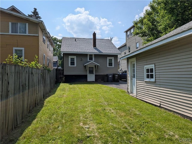 305 S Midler Ave, Syracuse, NY 13206 - rear view of property with a chimney and roof with shingles