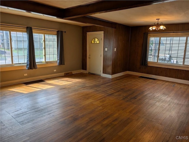 305 S Midler Ave, Syracuse, NY 13206 - empty room with a chandelier, wood finished floors, plenty of natural light, beam ceiling, and wooden walls