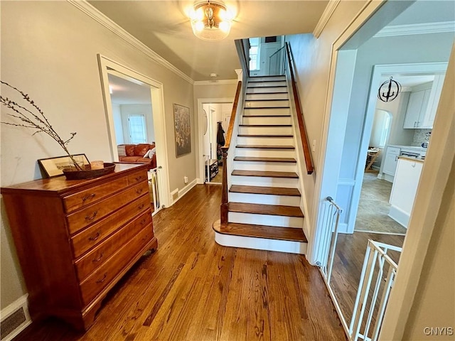 308 Haddonfield Dr, Dewitt, NY 13214 - stairs featuring wood finished floors, crown molding, and arched walkways