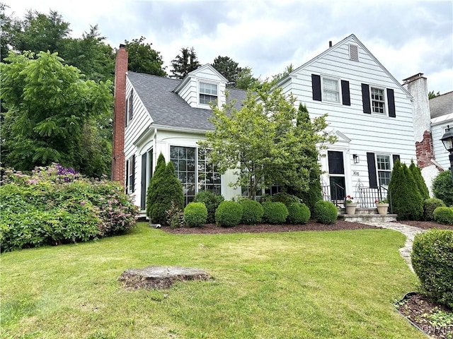 308 Haddonfield Dr, Dewitt, NY 13214 - view of front of property with a front lawn, a chimney, and roof with shingles