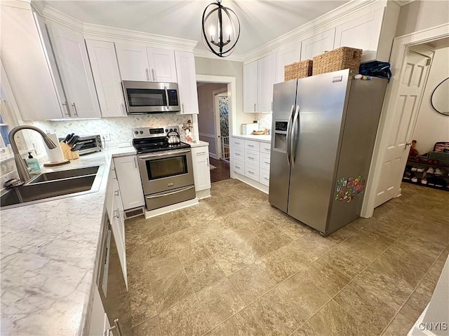308 Haddonfield Dr, Dewitt, NY 13214 - kitchen with appliances with stainless steel finishes, a chandelier, backsplash, white cabinetry, and pendant lighting