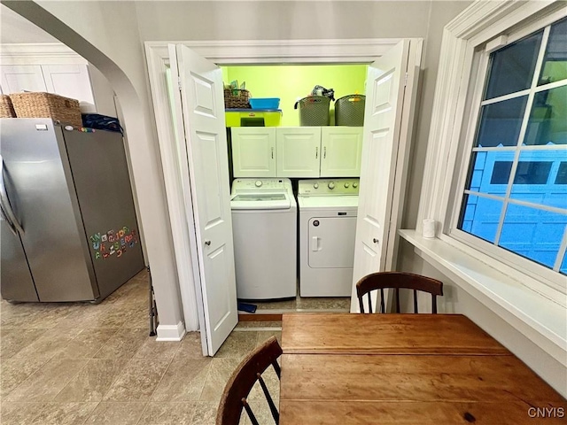 308 Haddonfield Dr, Dewitt, NY 13214 - laundry room featuring separate washer and dryer, cabinet space, and arched walkways