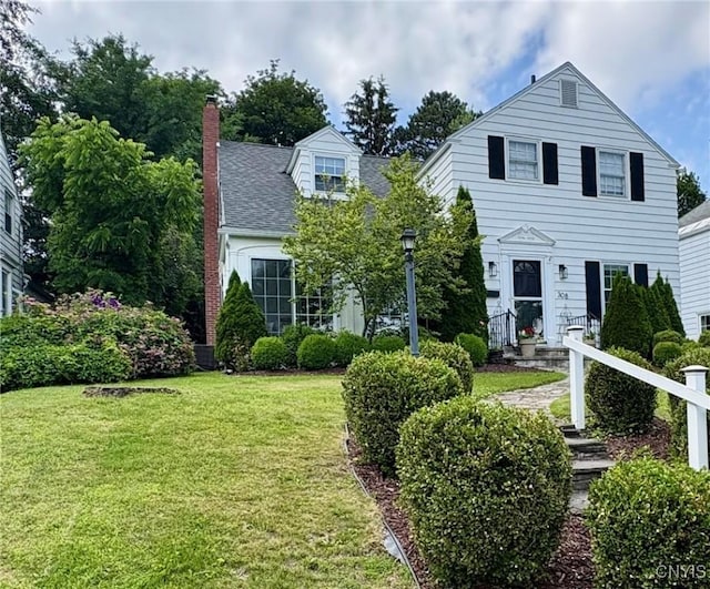 308 Haddonfield Dr, Dewitt, NY 13214 - view of front of house with a front lawn, a chimney, and a shingled roof