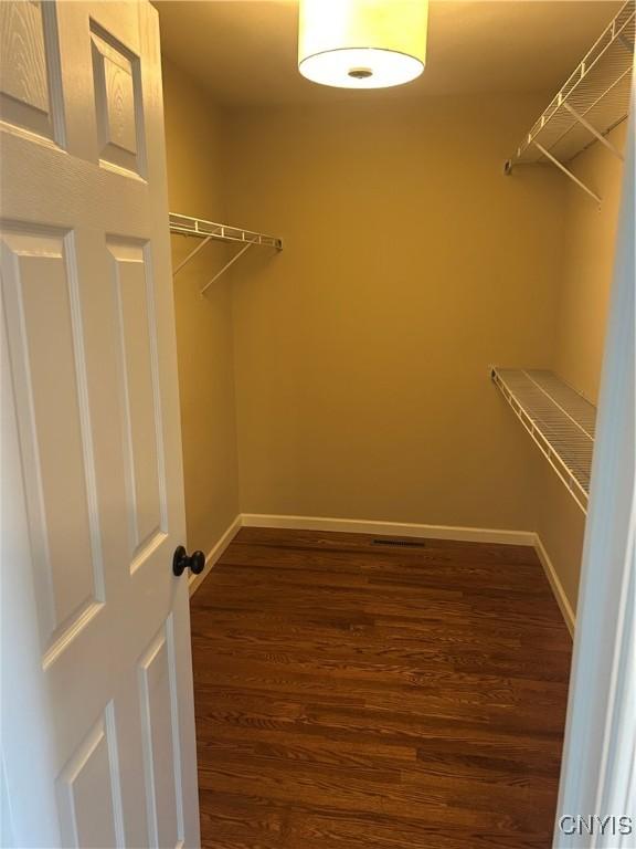 4745 Lynnville, Clay, NY 13041 - walk in closet featuring dark wood-type flooring