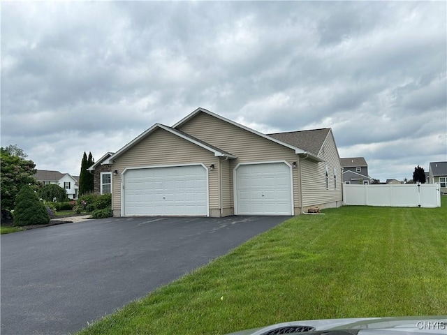 4745 Lynnville, Clay, NY 13041 - view of front of house with a garage and asphalt driveway