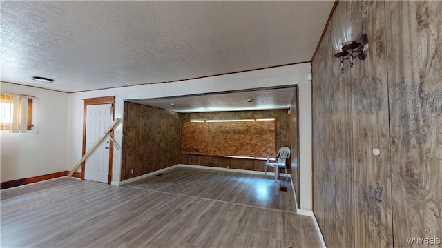 133 Freund St, Buffalo, NY 14215 - unfurnished living room featuring wood finished floors and wood walls