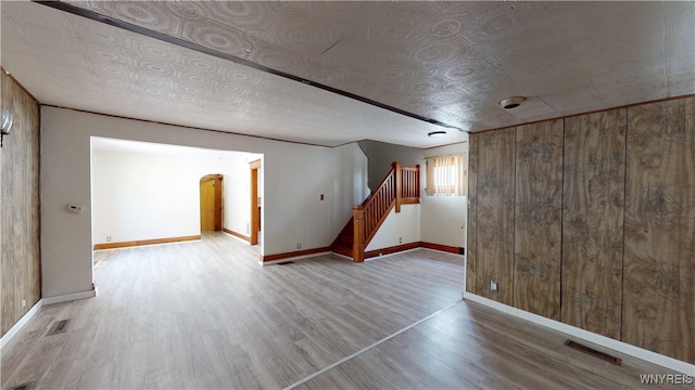 133 Freund St, Buffalo, NY 14215 - below grade area featuring wood finished floors, stairs, wooden walls, and arched walkways