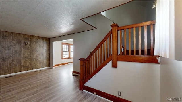 133 Freund St, Buffalo, NY 14215 - staircase with wood finished floors and wood walls