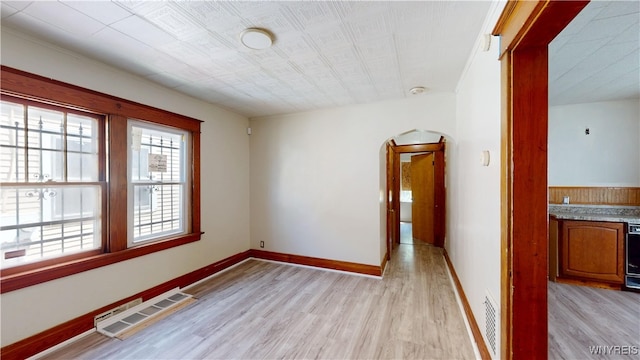 133 Freund St, Buffalo, NY 14215 - unfurnished room with light wood-style flooring, arched walkways, and a smoke detector