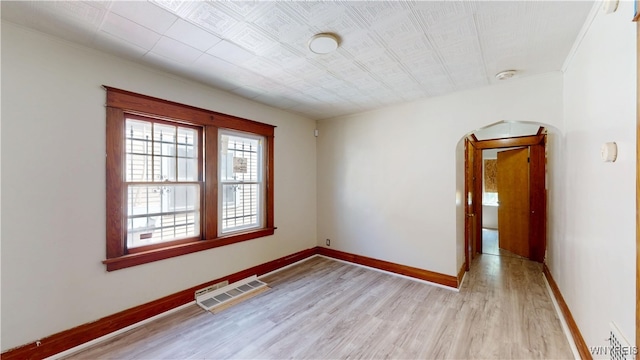 133 Freund St, Buffalo, NY 14215 - spare room with arched walkways, light wood finished floors, crown molding, and a smoke detector
