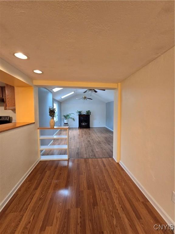 259 Flower Ave W, Watertown-City, NY 13601 - hall with wood finished floors, lofted ceiling, and a textured ceiling