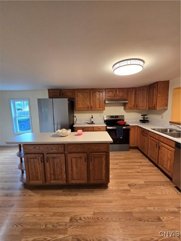 259 Flower Ave W, Watertown-City, NY 13601 - kitchen with appliances with stainless steel finishes, light wood-style flooring, light countertops, and brown cabinetry