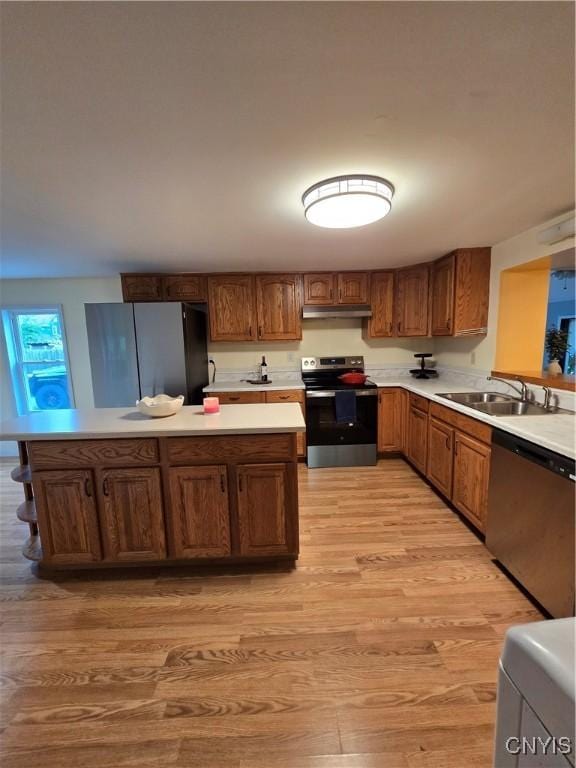 259 Flower Ave W, Watertown-City, NY 13601 - kitchen with appliances with stainless steel finishes, under cabinet range hood, light wood-style floors, and light countertops
