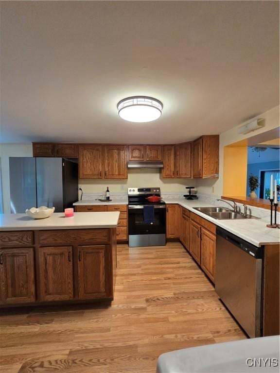 259 Flower Ave W, Watertown-City, NY 13601 - kitchen with appliances with stainless steel finishes, under cabinet range hood, light wood-style flooring, light countertops, and a peninsula