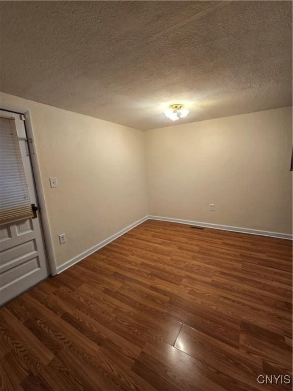 259 Flower Ave W, Watertown-City, NY 13601 - spare room featuring dark wood finished floors and a textured ceiling
