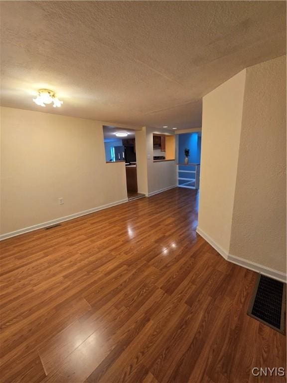 259 Flower Ave W, Watertown-City, NY 13601 - empty room featuring dark wood-style floors and a textured ceiling