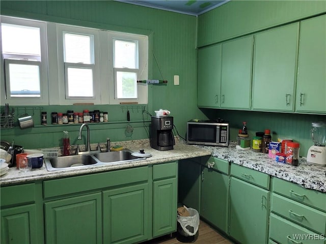 196 Kilhoffer St Unit B, Buffalo, NY 14211 - kitchen with stainless steel microwave, light countertops, green cabinetry, and crown molding