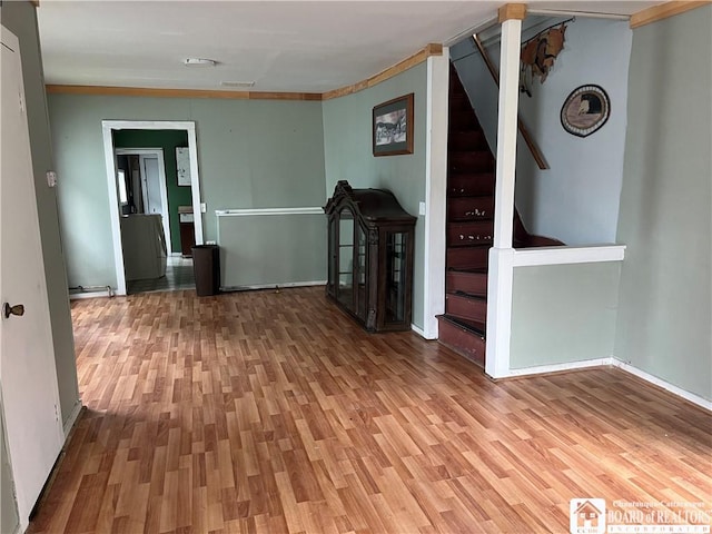 1014 N Union St, Olean-City, NY 14760 - unfurnished room featuring light wood-style flooring, stairs, a smoke detector, and crown molding
