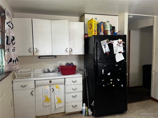 401 Ideal St, Buffalo, NY 14206 - kitchen with freestanding refrigerator, light countertops, white cabinets, and light flooring