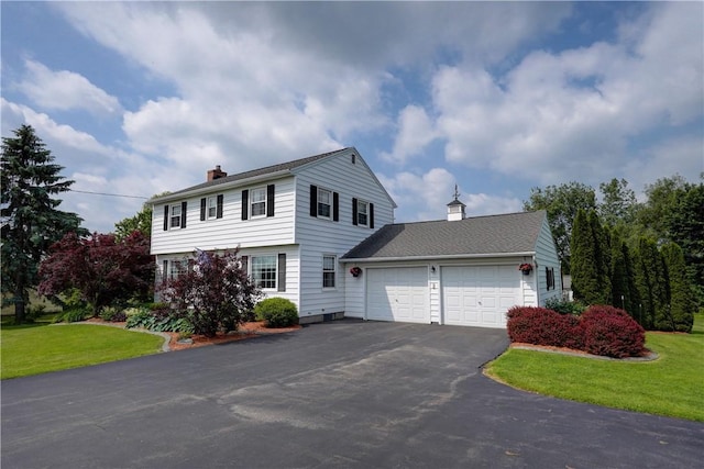 921 Wayneport Rd, Macedon, NY 14502 - colonial house with a chimney, asphalt driveway, a garage, and a front lawn