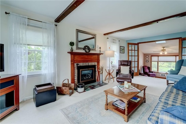 921 Wayneport Rd, Macedon, NY 14502 - carpeted living room with beamed ceiling, a fireplace with flush hearth, and a ceiling fan