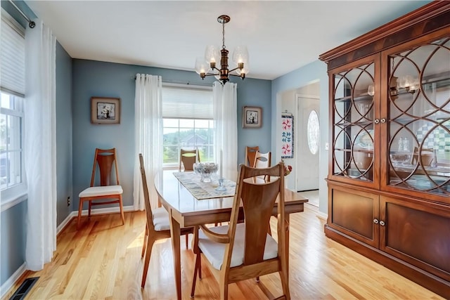921 Wayneport Rd, Macedon, NY 14502 - dining area with a chandelier and light wood finished floors