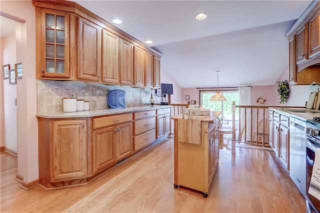921 Wayneport Rd, Macedon, NY 14502 - kitchen featuring light wood-type flooring, vaulted ceiling, a center island, tasteful backsplash, and glass insert cabinets