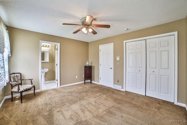 6850 Shawnee Rd, Wheatfield, NY 14120 - carpeted bedroom featuring a textured ceiling, a ceiling fan, ensuite bathroom, and a closet